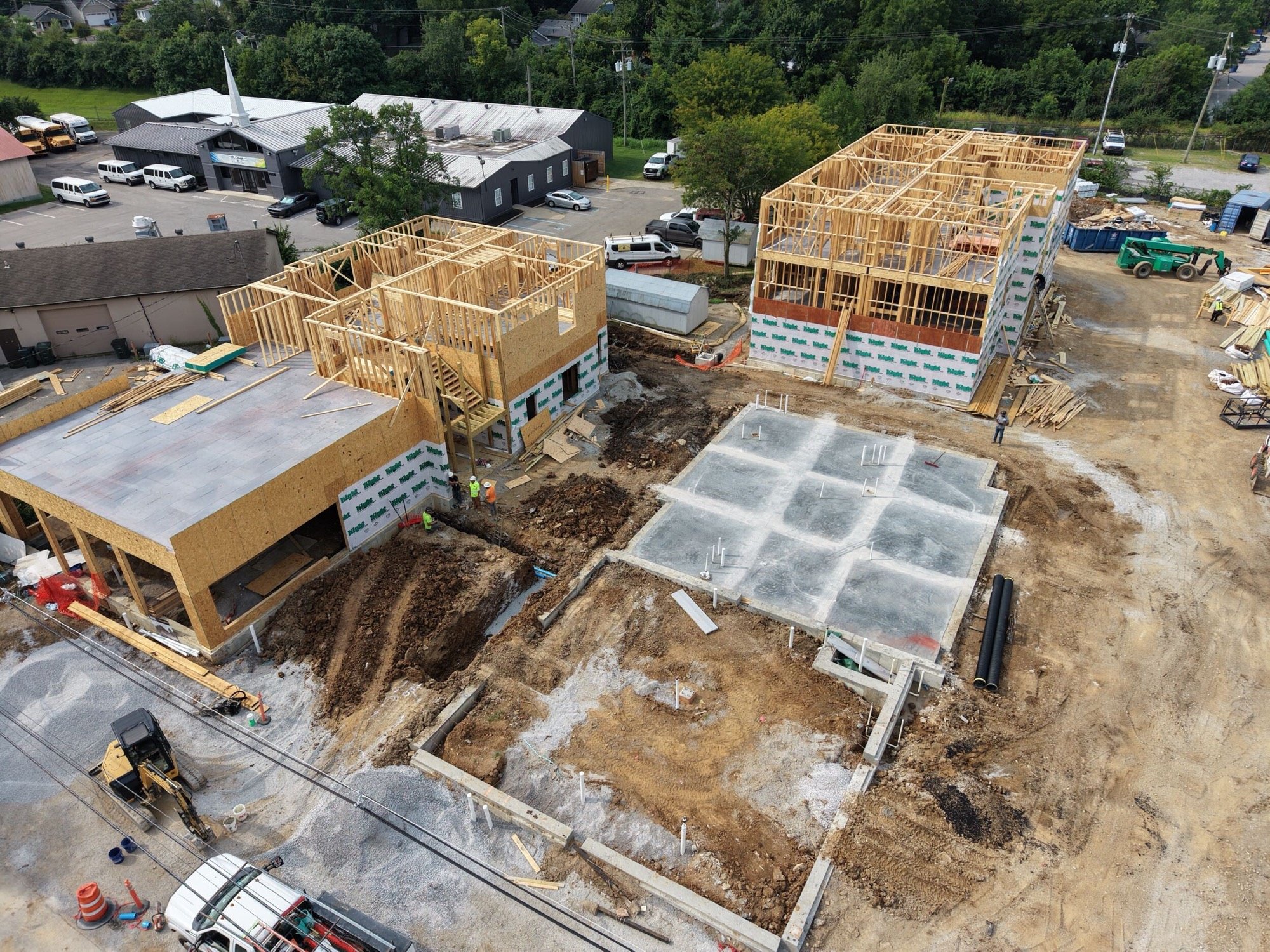 Aerial view of The Railyard under construction in Lexington, Kentucky, showing framed buildings and a central foundation.
